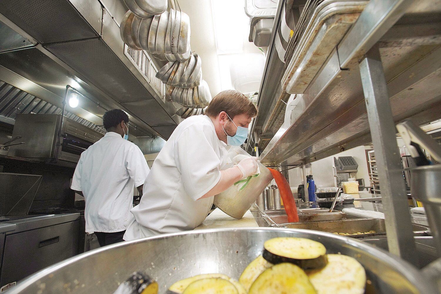 Staff prepare takeout meals at Mazzeo's Ristorante in the spring